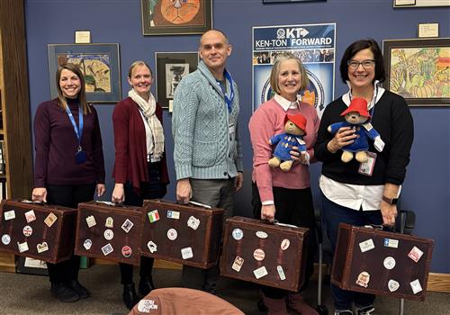  Librarians pose with suitcases and Paddington Bears
